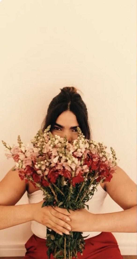 Profissional da Guadalupe segurando um buquê de flores